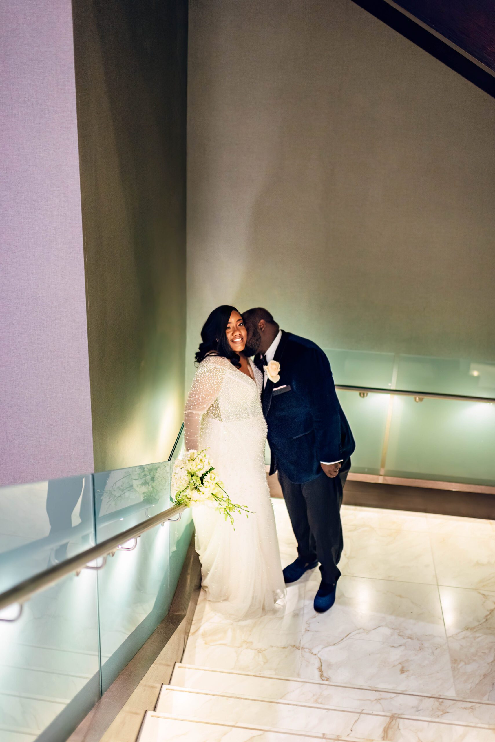Bride and groom in stairwell in Kimpton Tryon Park hotel