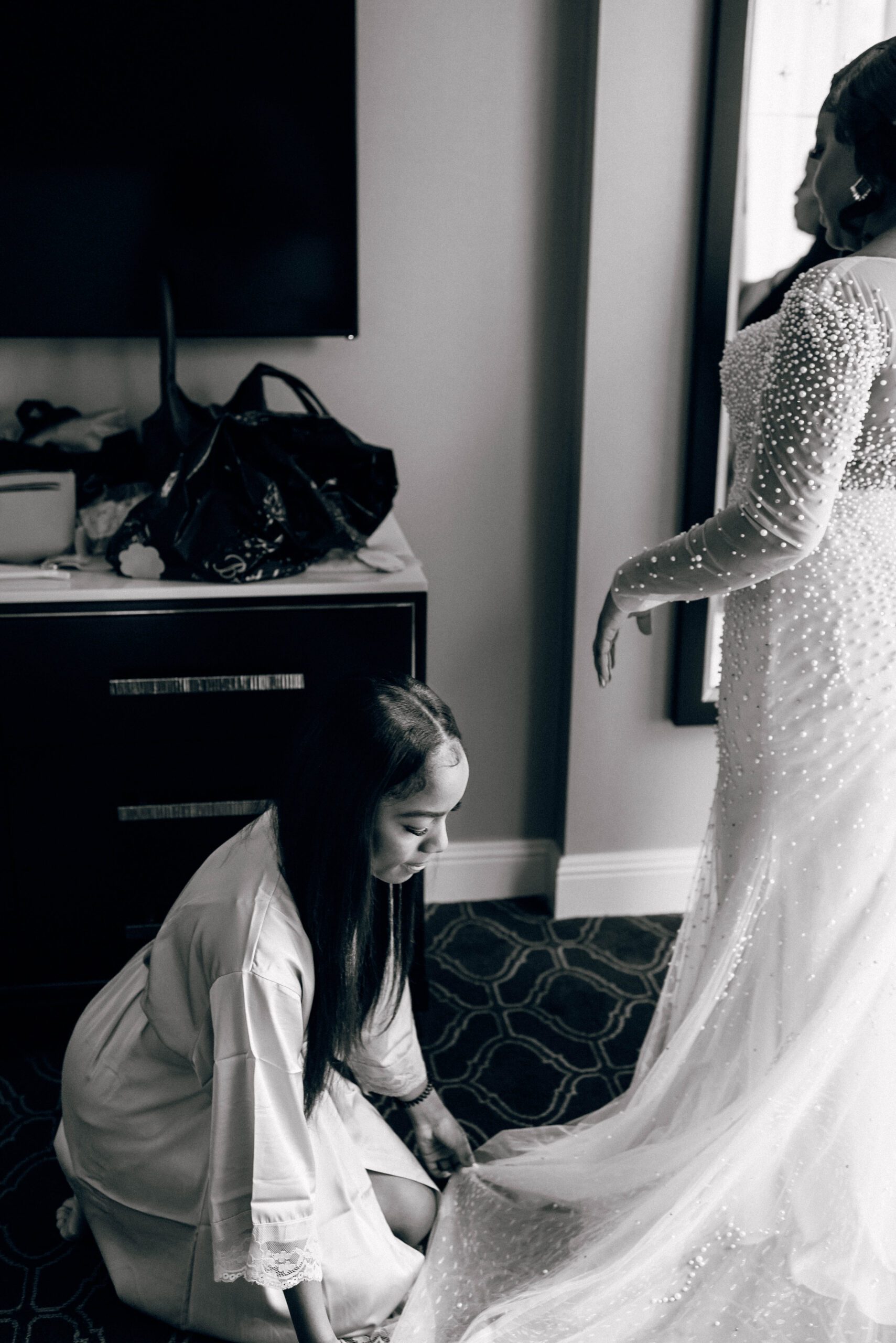 Bride getting ready with the help of her bridesmaids